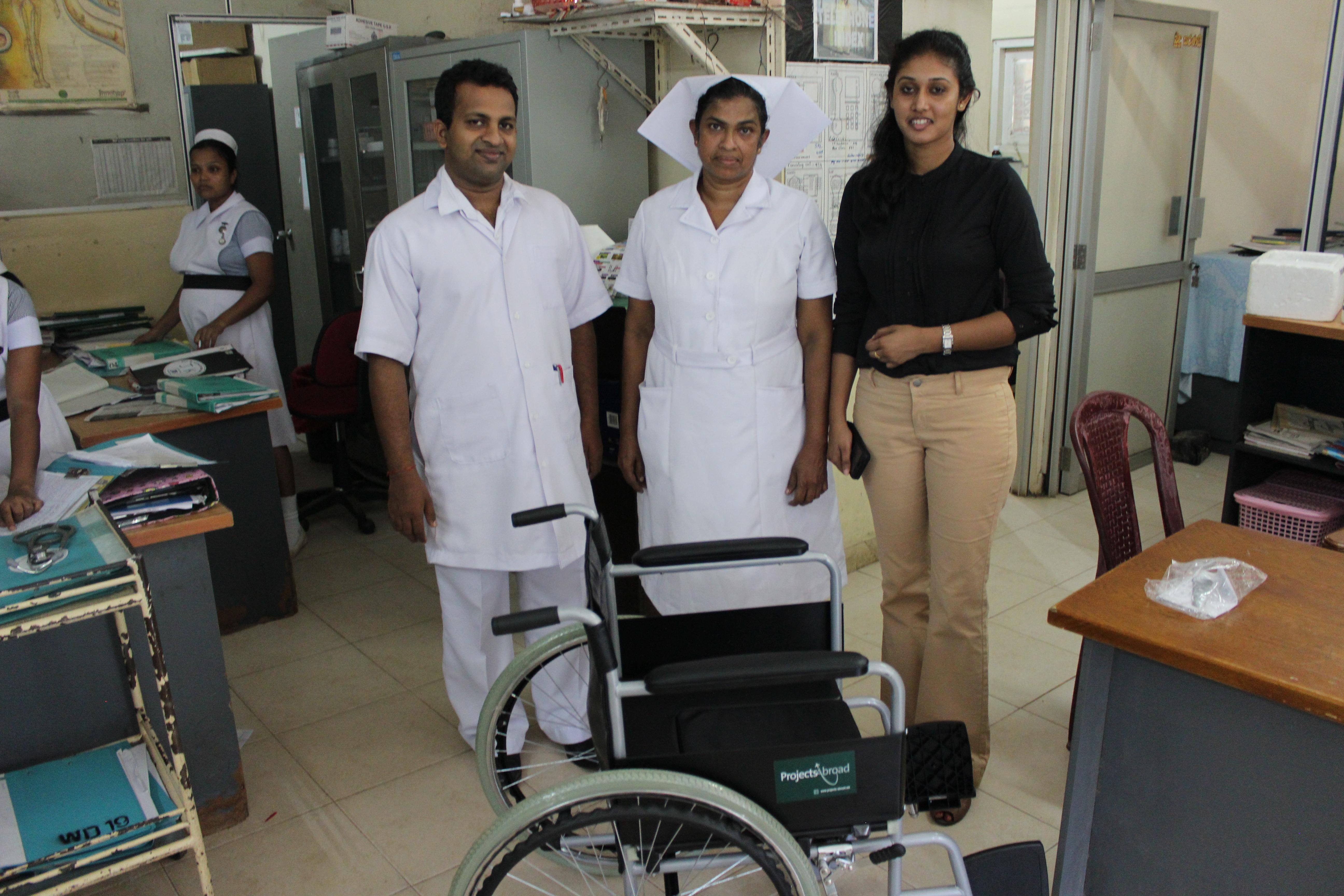 Interns giving local doctors and nurses a wheelchair donated by Projects Abroad whilst on a physiotherapy internship in Sri Lanka. Doctors and nurses take a picture with wheelchair donated by Projects Abroad during an interns Physiotherapy internship in Sri Lanka.